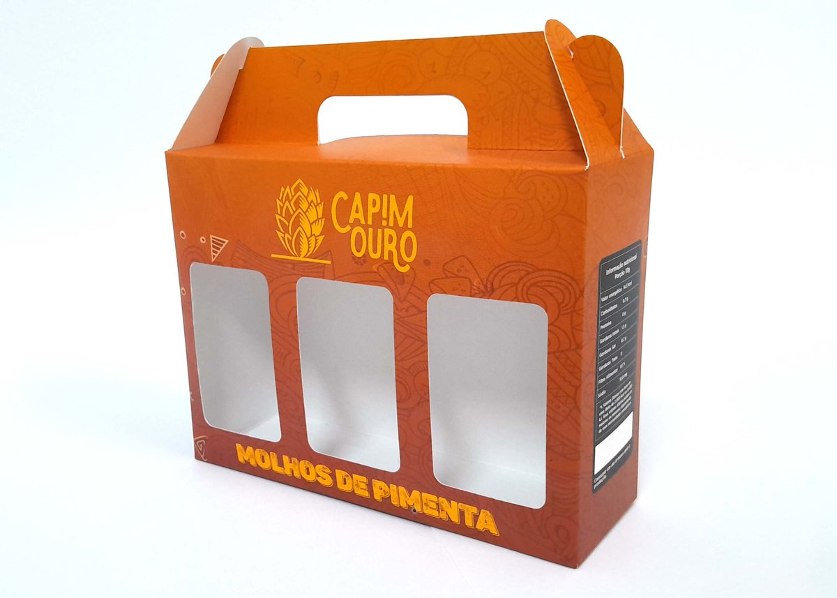 Embalagem de papel personalizada em laranja, com alça e três janelas vazadas, produzida pela Gráfica Flamboyant
